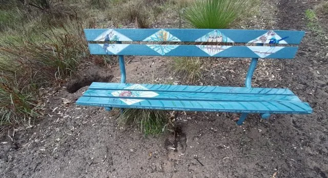 The beautifully painted bench seats are perfect for relaxing and enjoying nature at Periwinkle Park.